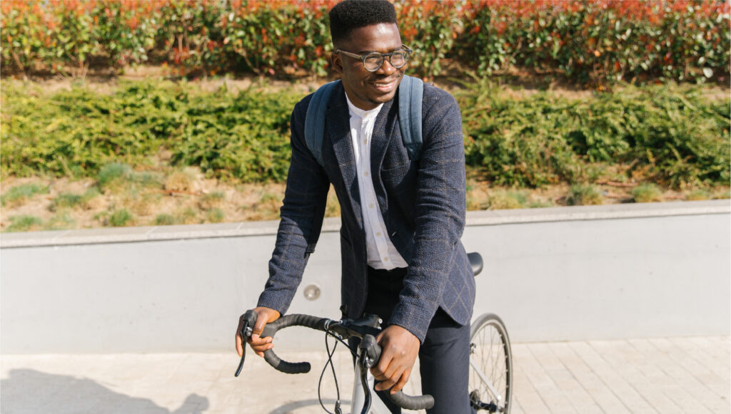 A person smiling while riding a road bike