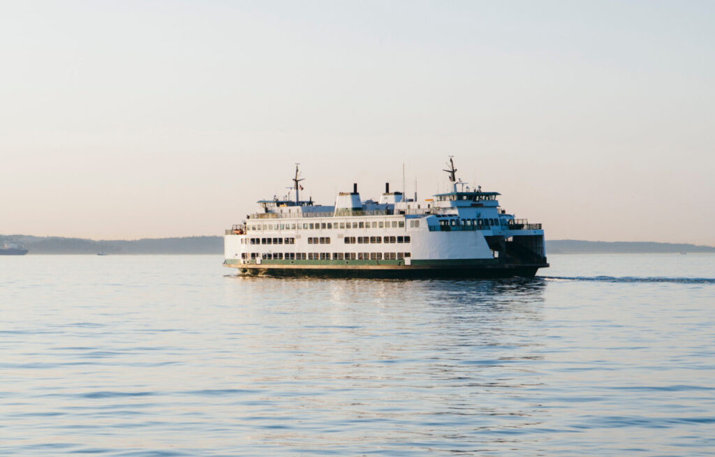 Ferry boat on calm waters of Puget Sound at dusk, Seattle, WA, USA